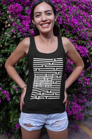 Beautiful maori women standing in front of a flowering plant, wearing a custom pepeha singlet by Mana Ake 